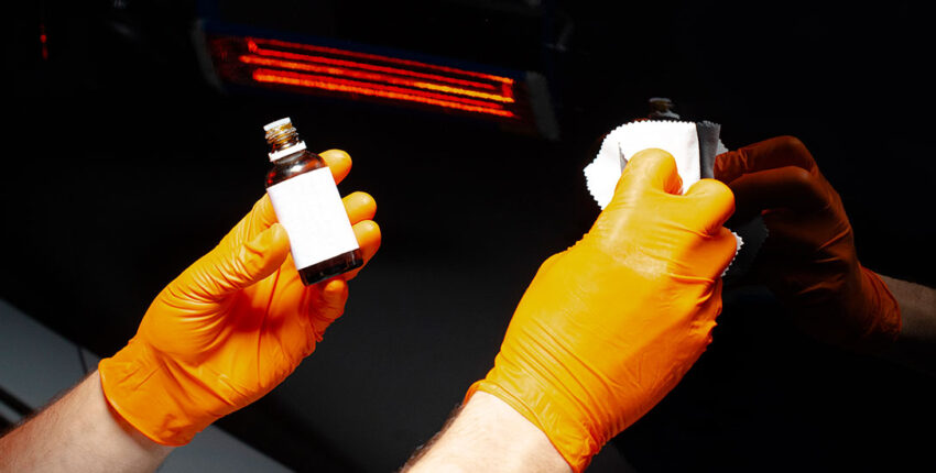 closeup of vehicle paint treatment during detailing