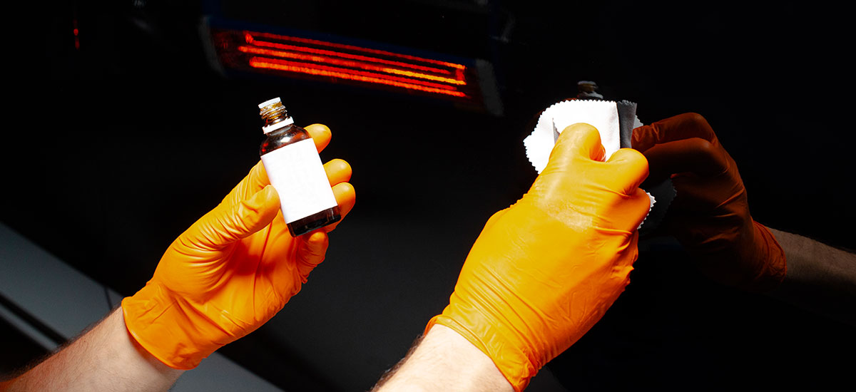 closeup of vehicle paint treatment during detailing