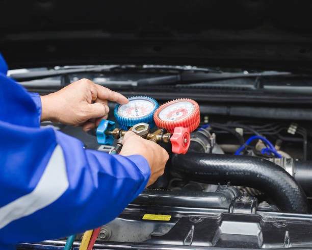 An expert technician carrying out engine diagnostics with the help of tools